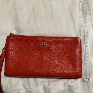 Coach orange wristlet. Vintage and well loved but in good condition.